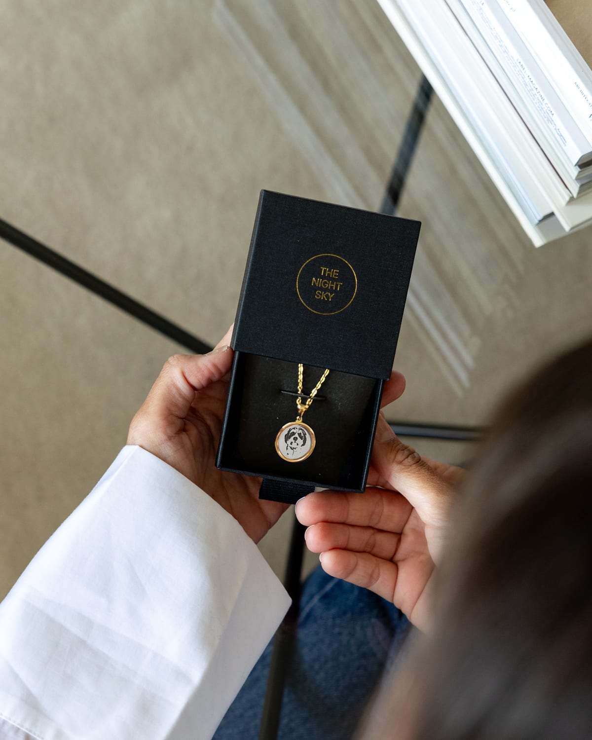 A gold vermeil pet pendant in a Night Sky gift box